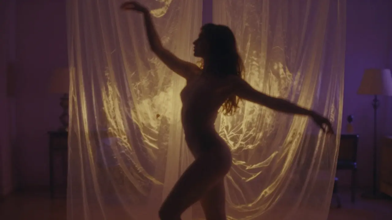 Artistic silhouette of a woman dancing behind translucent curtains in a moody studio.